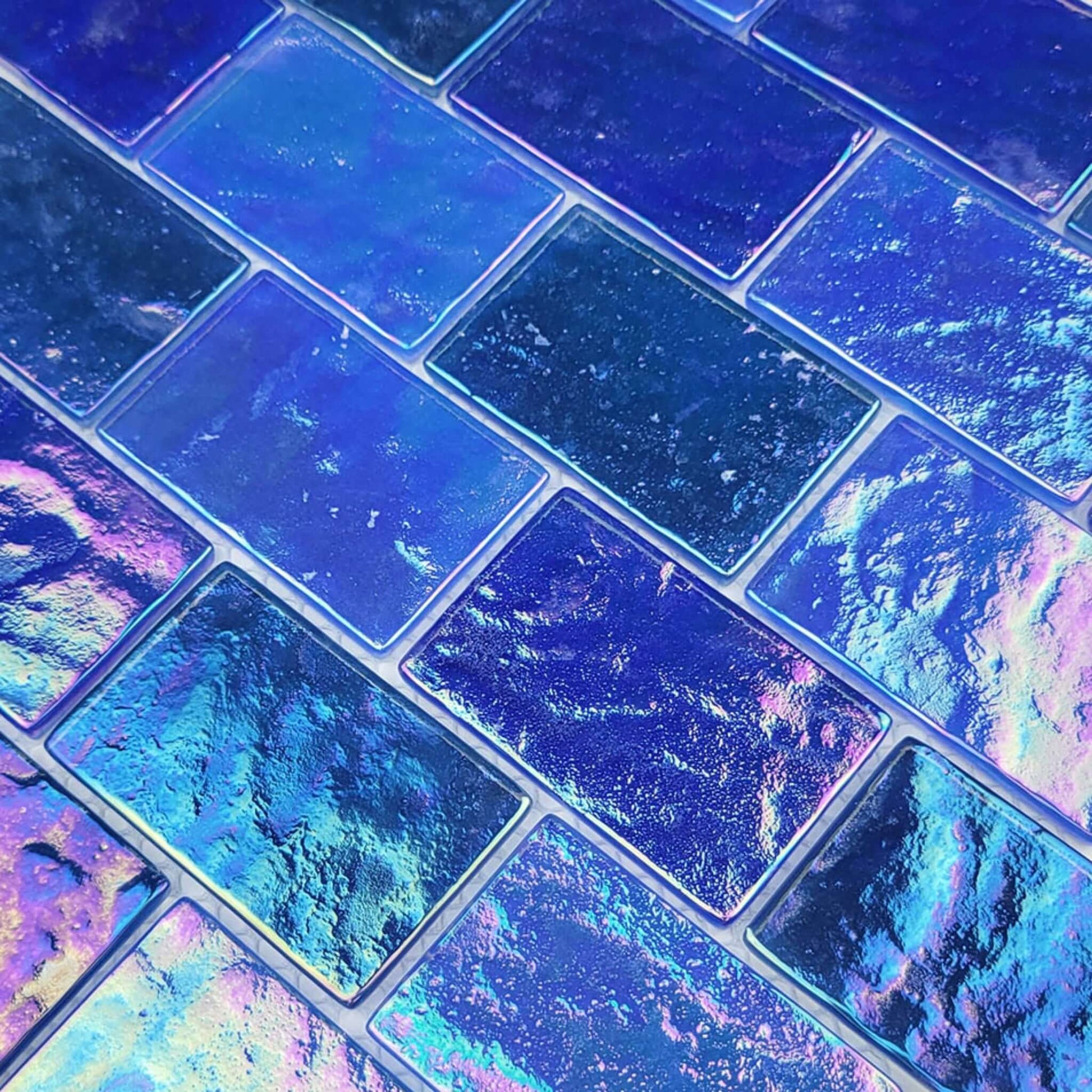 Artistry in Mosaics Ocean Series light blue glass tiles shown in a close-up view with iridescent finish, SKU GC64872B12. Discount Pool Mart DPM.