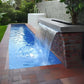 CMP Natural Wonders 72" x 6" Lip White Waterfall 25577-630-000 cascading into sparkling blue pool, enhancing outdoor beauty.