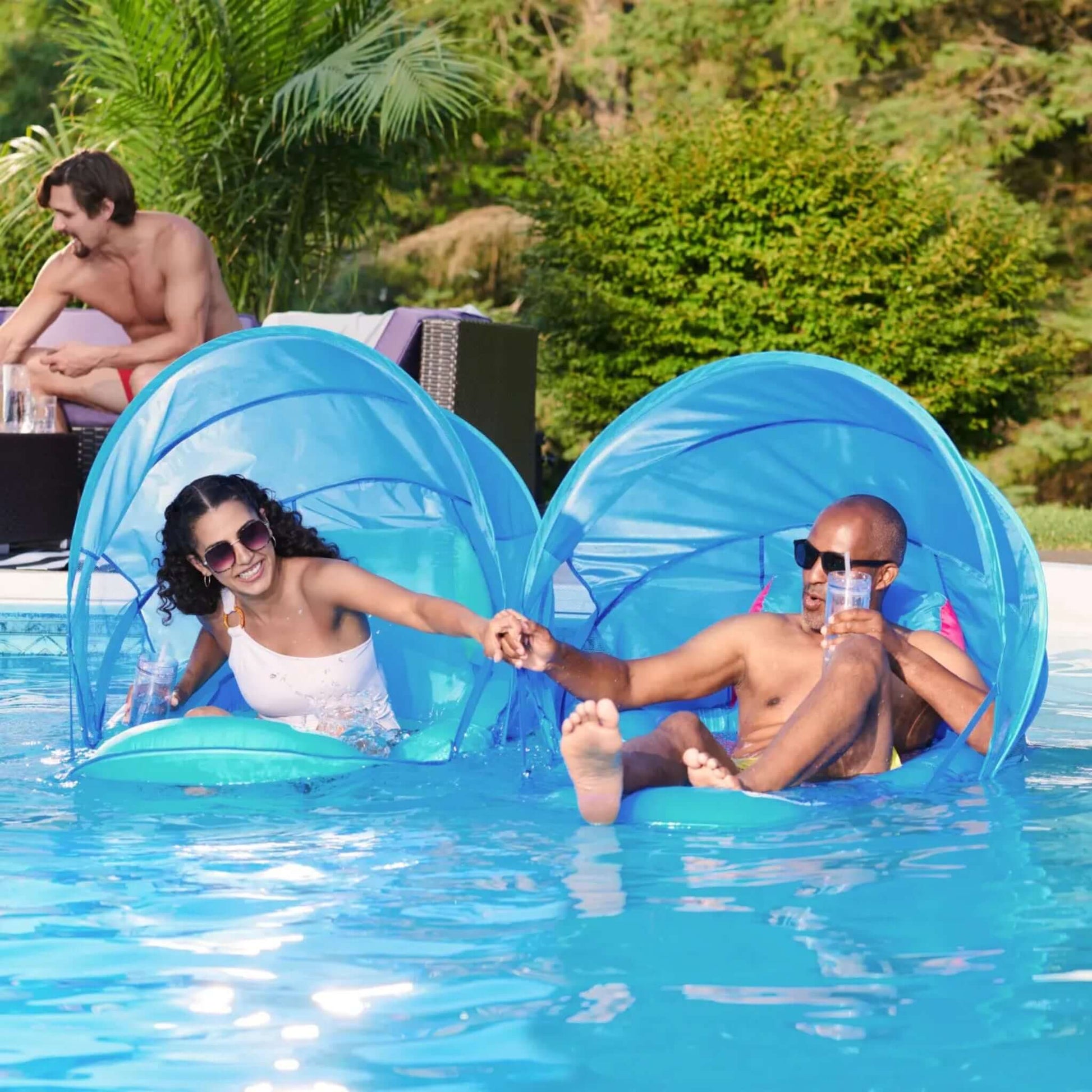 SwimWays Premium Spring Float Recliner w/Canopy at a pool, perfect for relaxation. SKU: 6069120, Discount Pool Mart DPM.