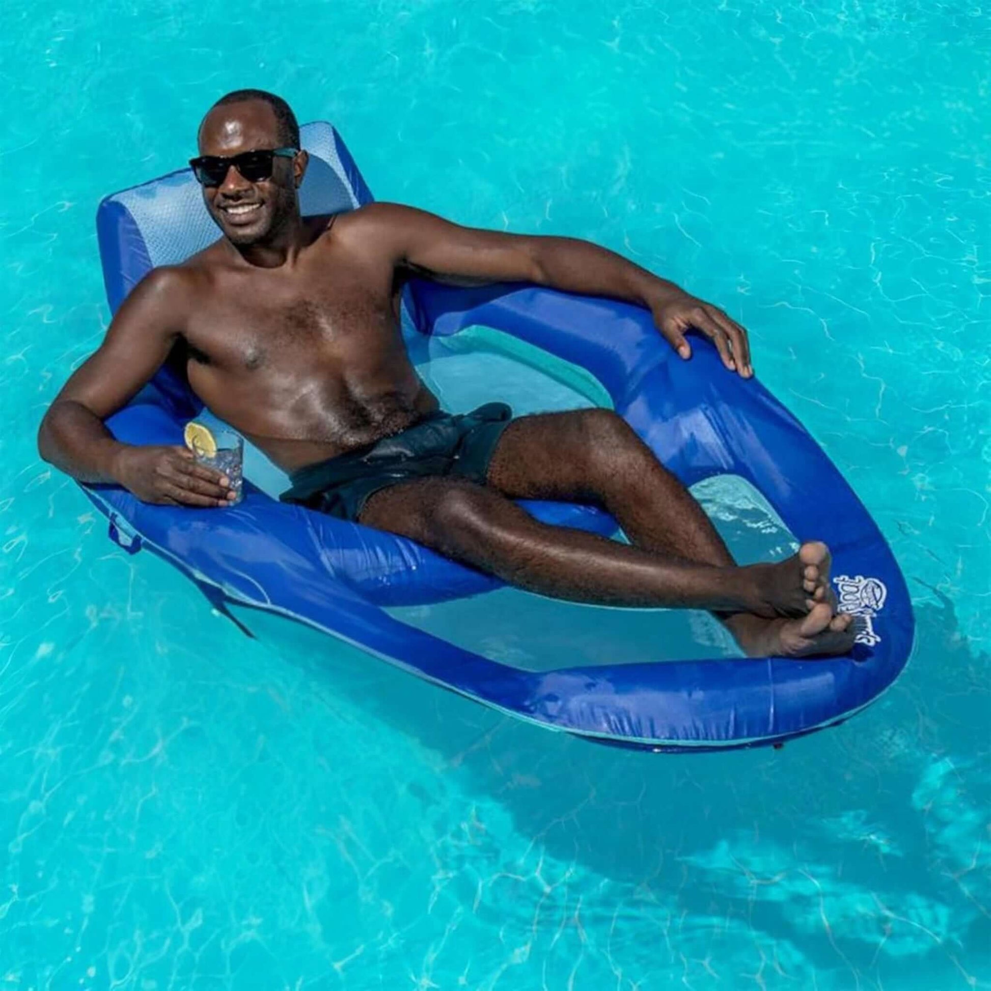 Man relaxing on a SwimWays Spring Float Recliner XL in a pool, SKU 6069706, available at Discount Pool Mart DPM.