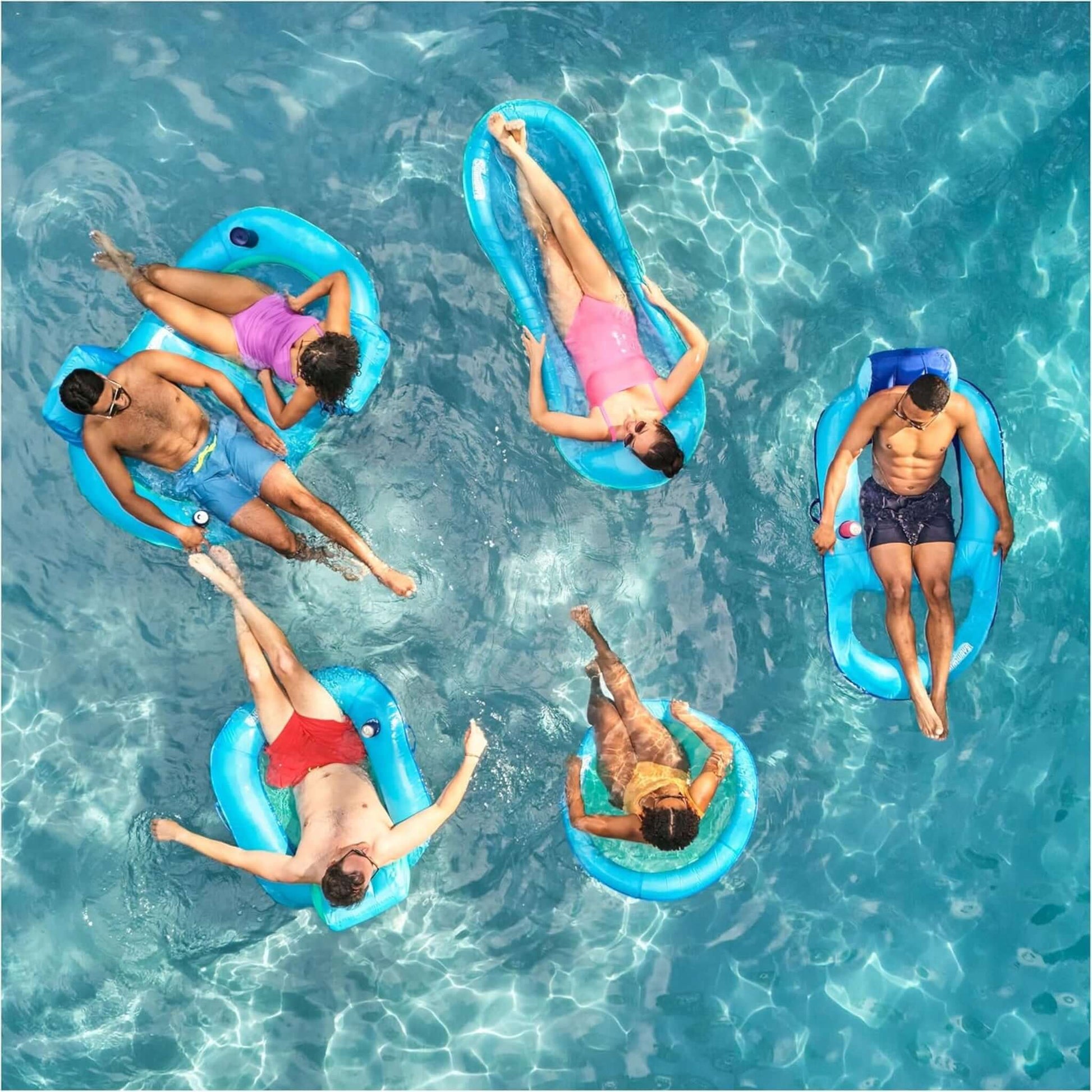 Group of friends relaxing on SwimWays Premium Spring Float Duo in a sparkling pool. SKU 6071270 available at Discount Pool Mart DPM.