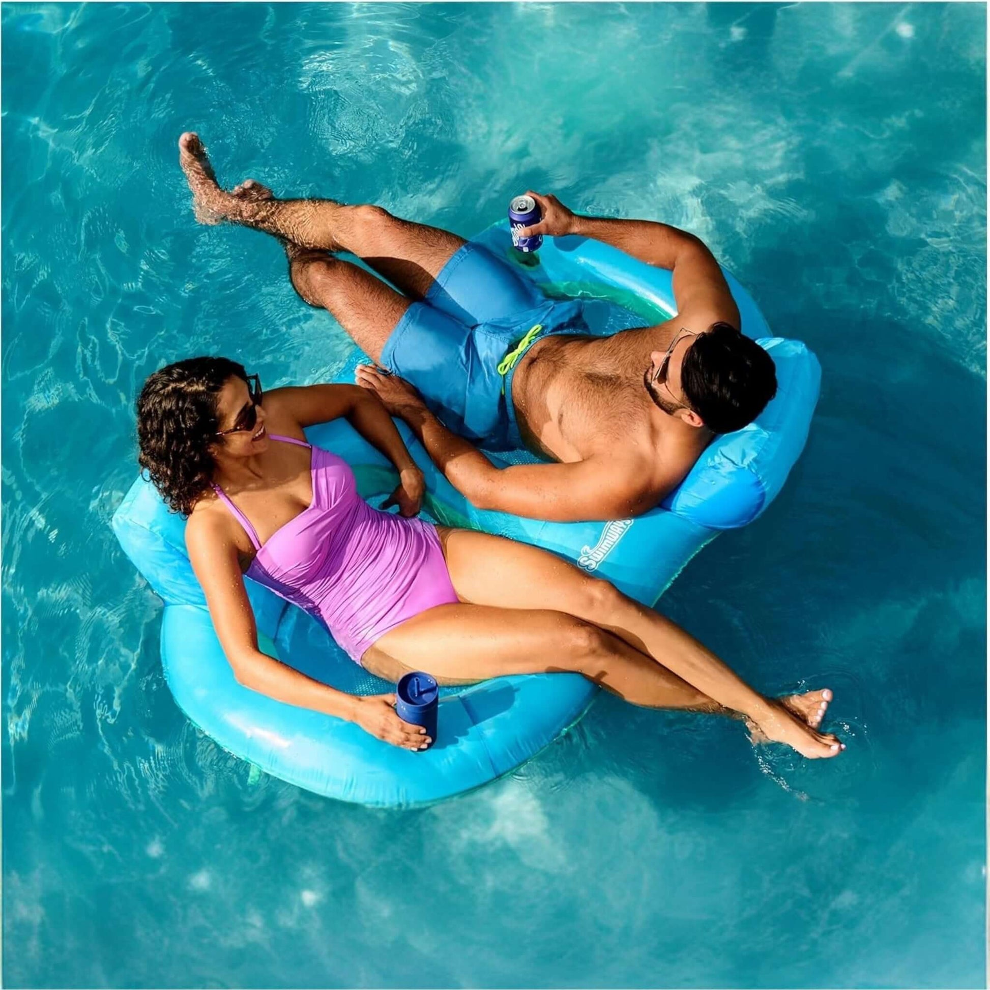 Couple relaxing on SwimWays Premium Spring Float Duo in the pool, SKU 6071270, from Discount Pool Mart (DPM).