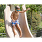 Child sliding down the S.R. Smith Typhoon Pool Slide, having fun on a sunny day, SKU: DPM-TY-LEFT