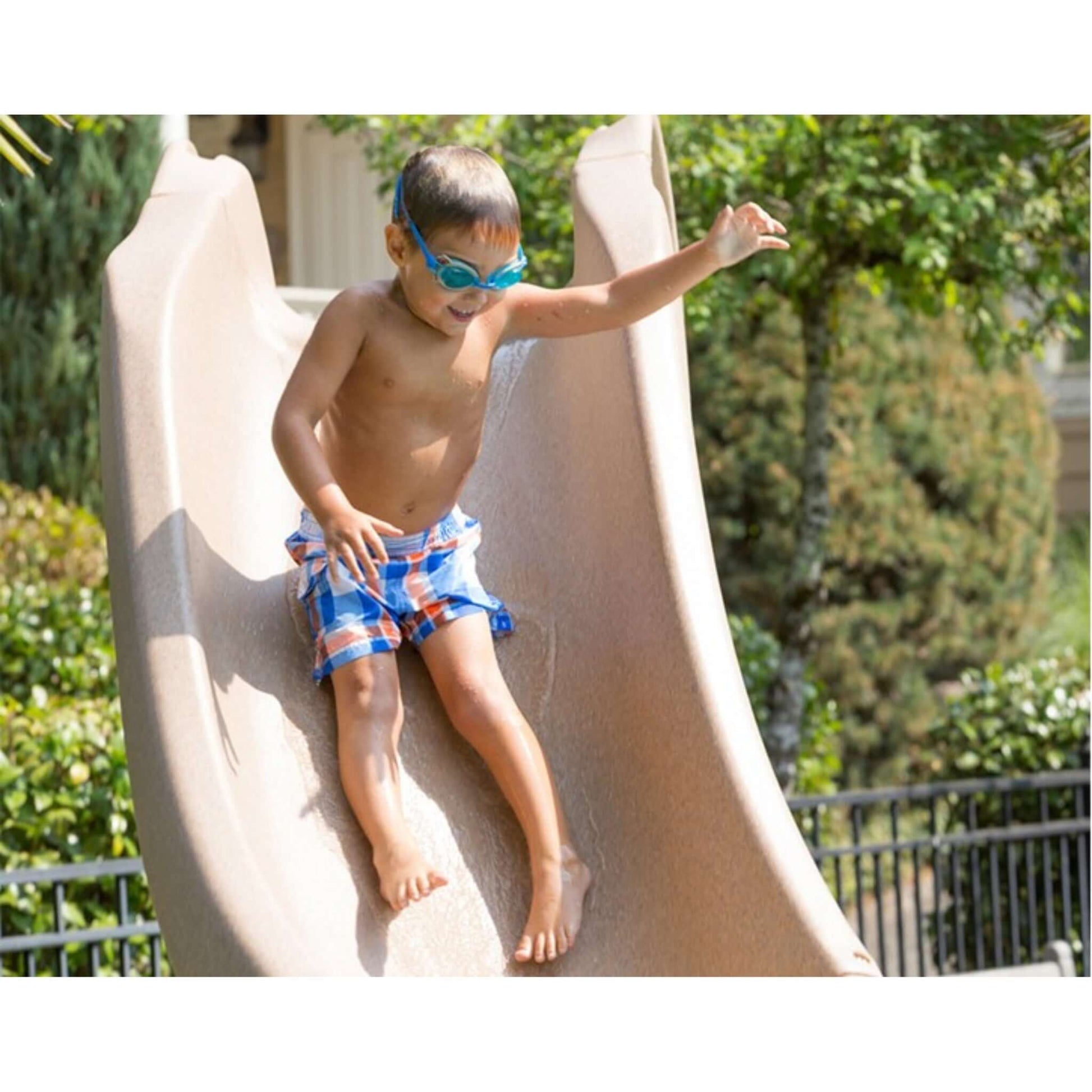 Child sliding down the S.R. Smith Typhoon Pool Slide, having fun on a sunny day, SKU: DPM-TY-LEFT