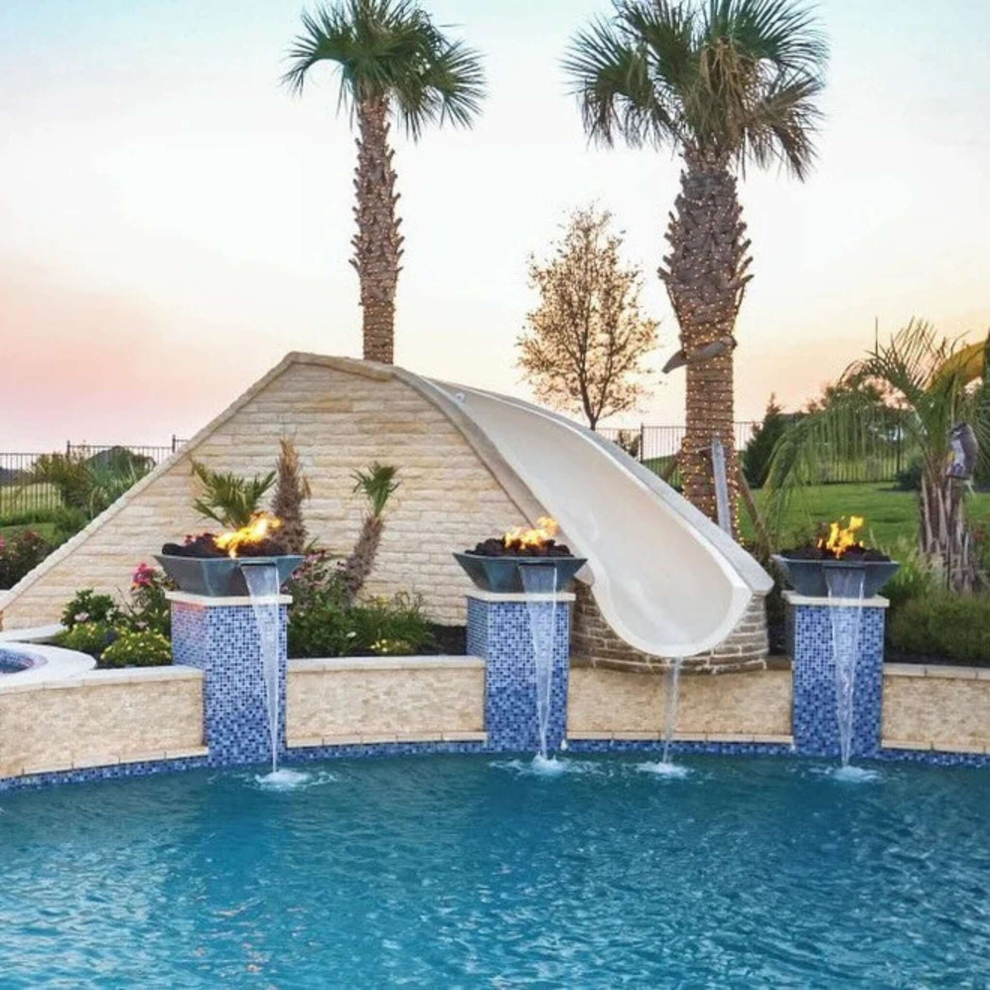 Grand Effects Corinthian Fire & Water Bowl Concrete at Discount Pool Mart DPM with palm trees and slide.