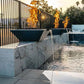 Grand Effects Corinthian Fire & Water Bowl Concrete by Discount Pool Mart DPM, featuring flames and water in a modern setting.