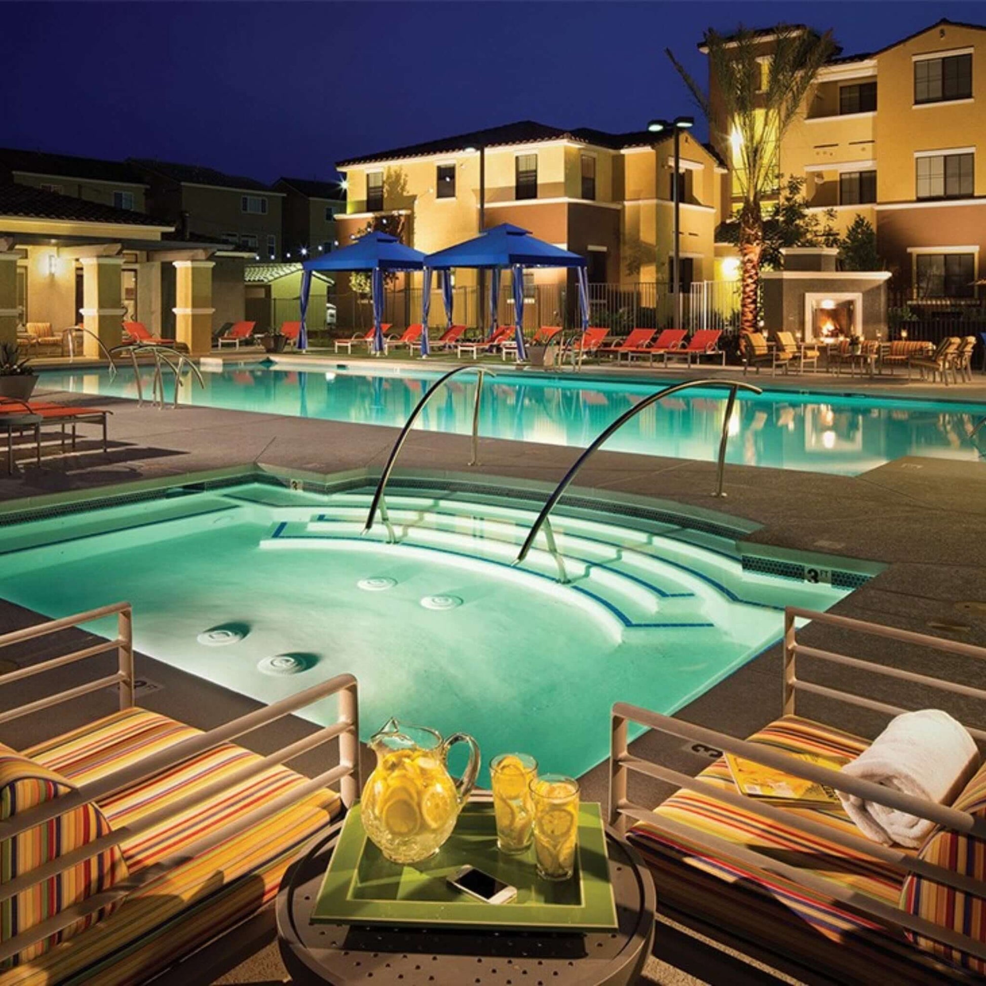 Elegant pool area at night featuring S.R. Smith Stair Rail, providing safety and style for poolside relaxation.