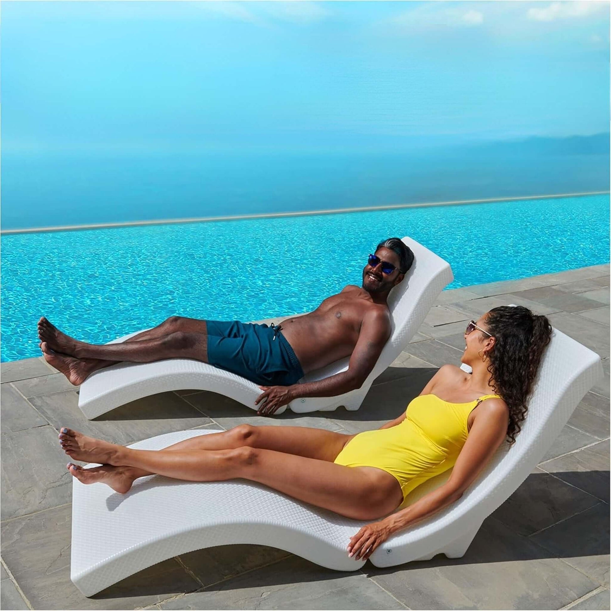 Couple lounging on SwimWays Terra Sol Sonoma Pool Lounge by poolside, enjoying the sun outdoors. SKU: SwimWays-TS0001