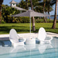 Two TenJam Woosah In-Pool Chairs under a gray umbrella, perfect for relaxing by the pool with DPM discount.