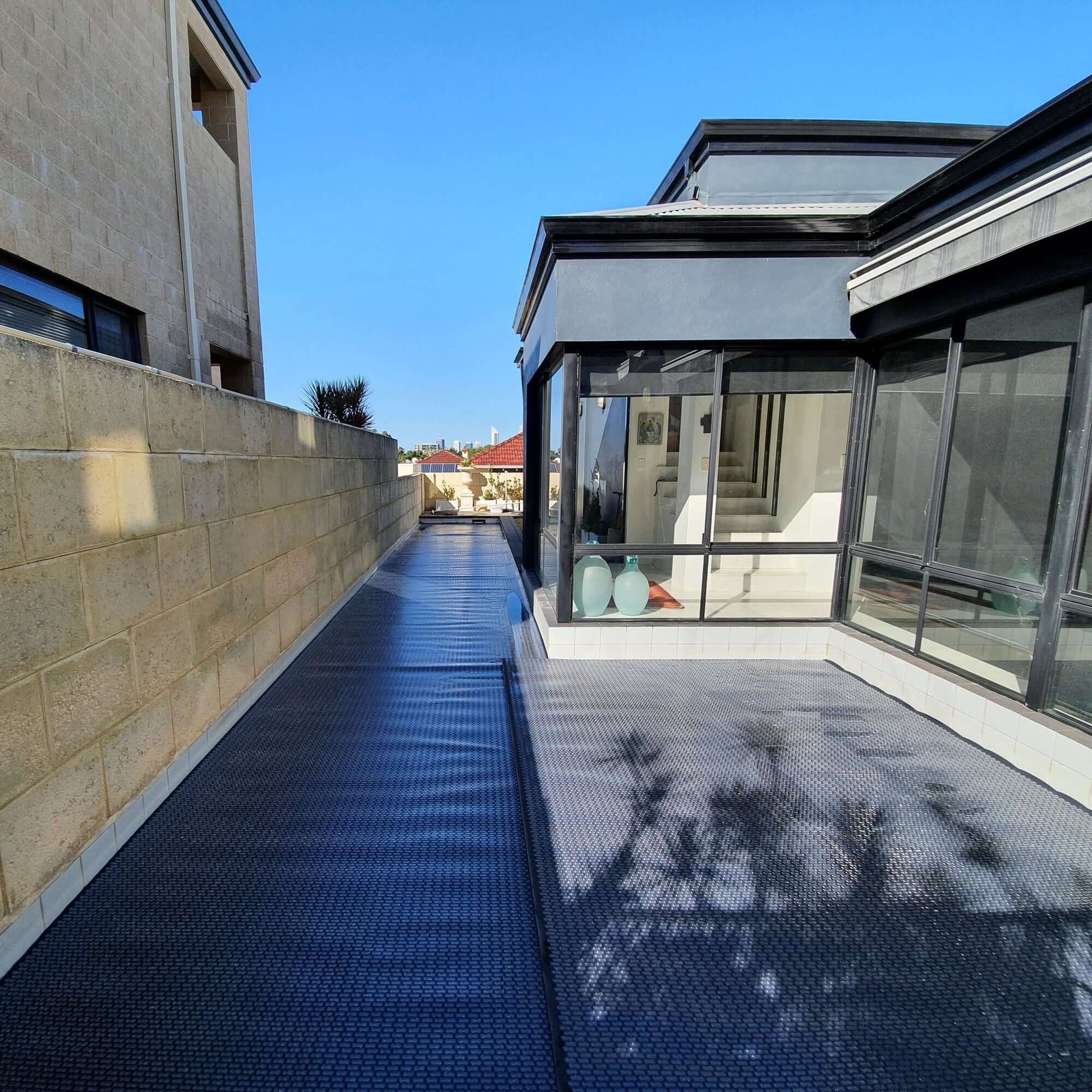Close-up of GeoBubble™ pool cover overlapping the edge of a pool, showing texture and fit.