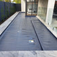 Close-up showing the texture and material quality of the EnergyGuard™ pool cover on the water's surface.