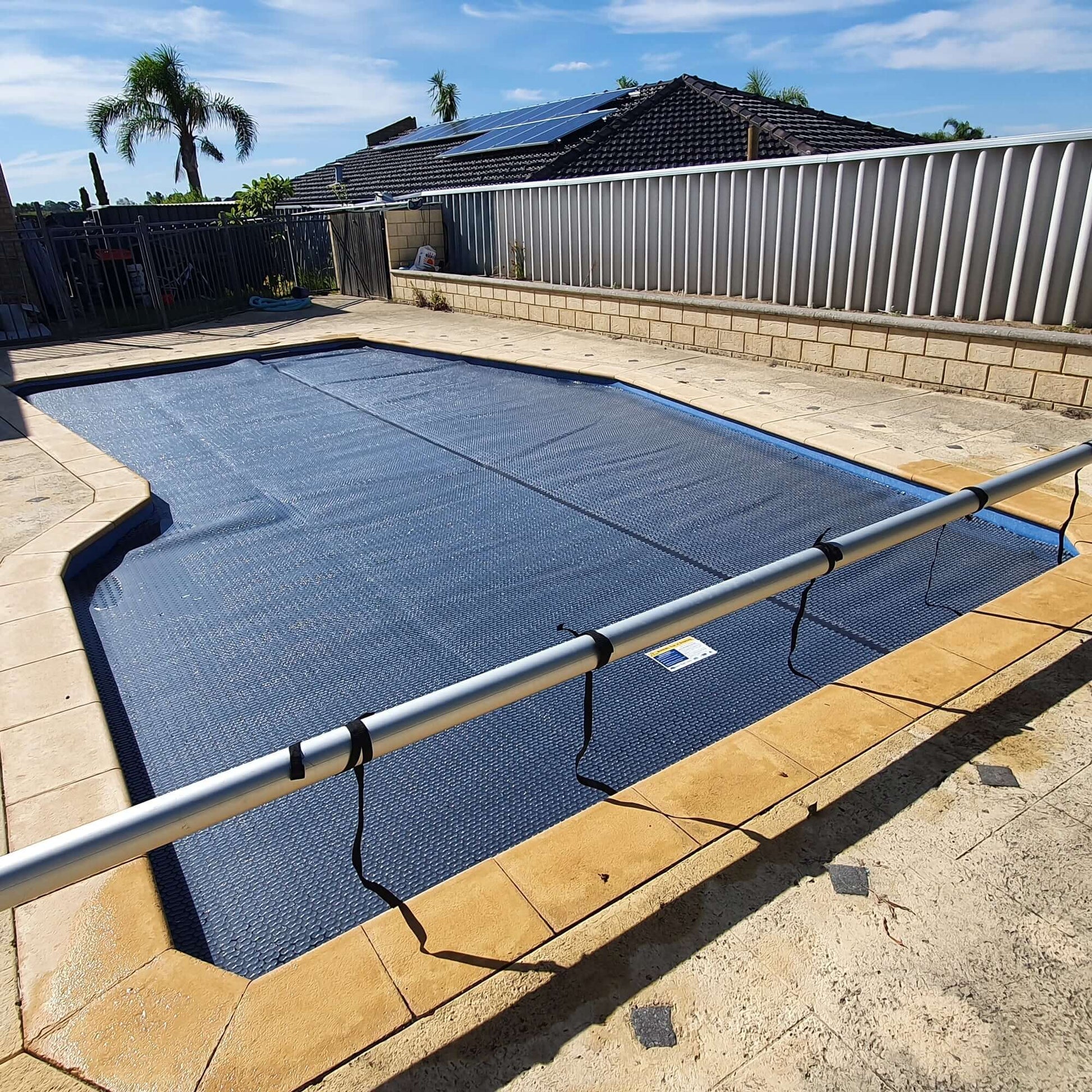 EnergyGuard™ solar cover custom-cut to fit pool steps for full surface protection.