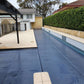 EnergyGuard™ GeoBubble™ solar cover installed on a rectangular inground swimming pool.