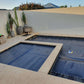 Sunset view of an inground pool protected with the EnergyGuard™ solar pool cover.