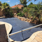 Inground pool with EnergyGuard™ GeoBubble cover installed, surrounded by backyard decking.