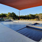 Clear view of the EnergyGuard™ solar cover fitted neatly over a bright blue inground pool.